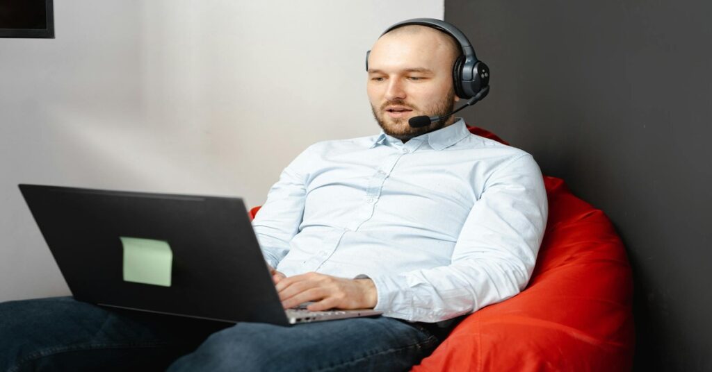 A Man Talking with someone on laptop with headphones | Earn Money from Virtual Assistant Jobs